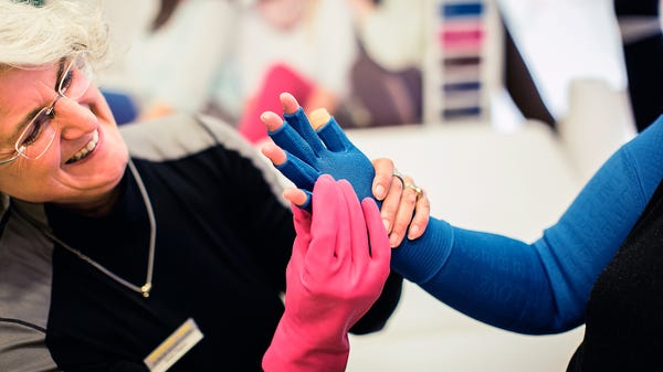 Woman fitting a lipoedema patient custom made mediven harmony gloves