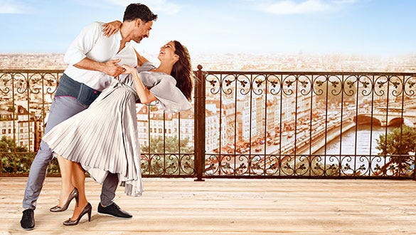 Happy couple  dancing on a rooftop showcasing the mans lumabmed back support