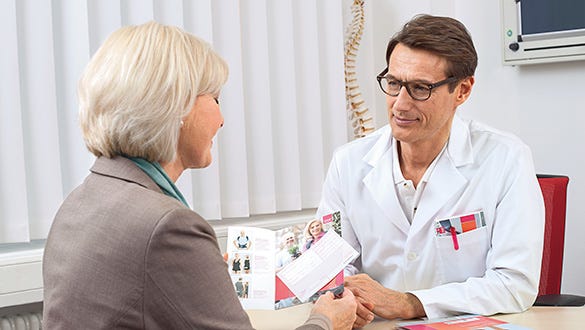 Woman at her doctors office getting informed about vein stripping