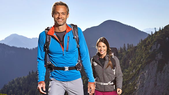 couple in their hiking gear, spending time in the mountains  training their caridovascular system
