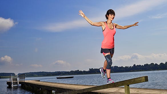 Woman balancing on a jetty thanks to her medi comfort foot supports