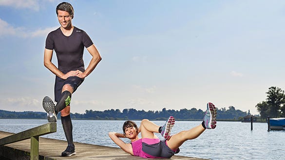 A man and  a woman  doing different exercises for stretching and the abdominal muscles on a jetty.