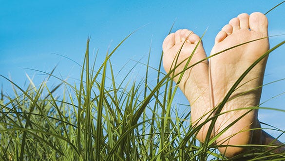 Image of a person who, suffers from the excessive sweating disorder Hyperhidrosis, feet in a meadow