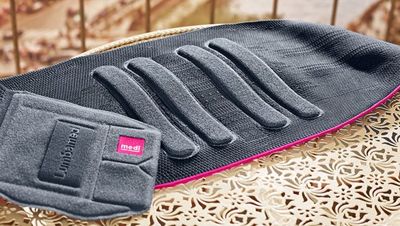 close up product shot of medi lumbamed back support lying on a golden side table
