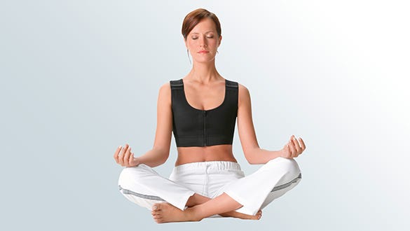 Woman, wearing  a medi compression bra, doing relaxing exercises
