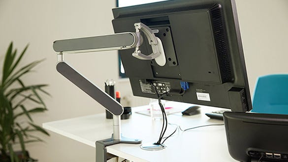 movable screen holder to encourage dynamic sitting and increase an ergonomic workplace