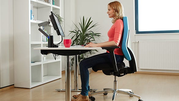 woman working in an ergonomic workplace to protect herself from back or neck pain