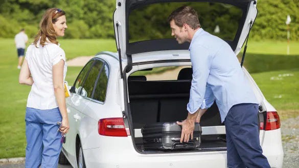 couple packing their car and preparing themselves to stay healthy on the road