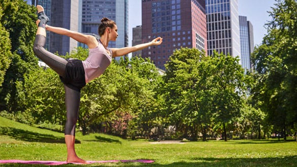 Woman doing the warrior yoga pose while showcasing her medi ankle support